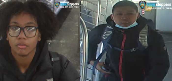 suspects, both wearing black jackets, who allegedlty damaged train doors