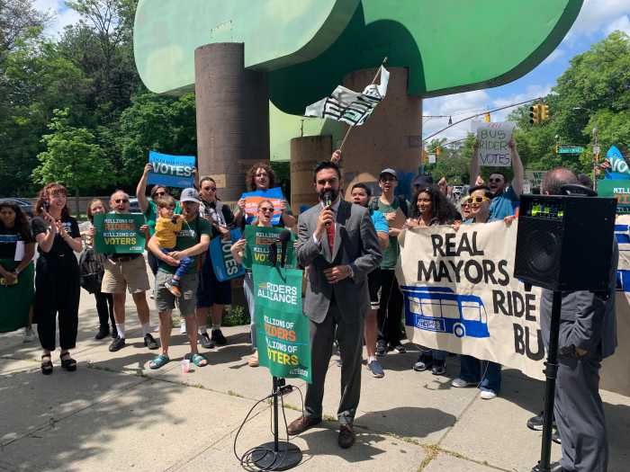 group of people holding signs at a bus rally