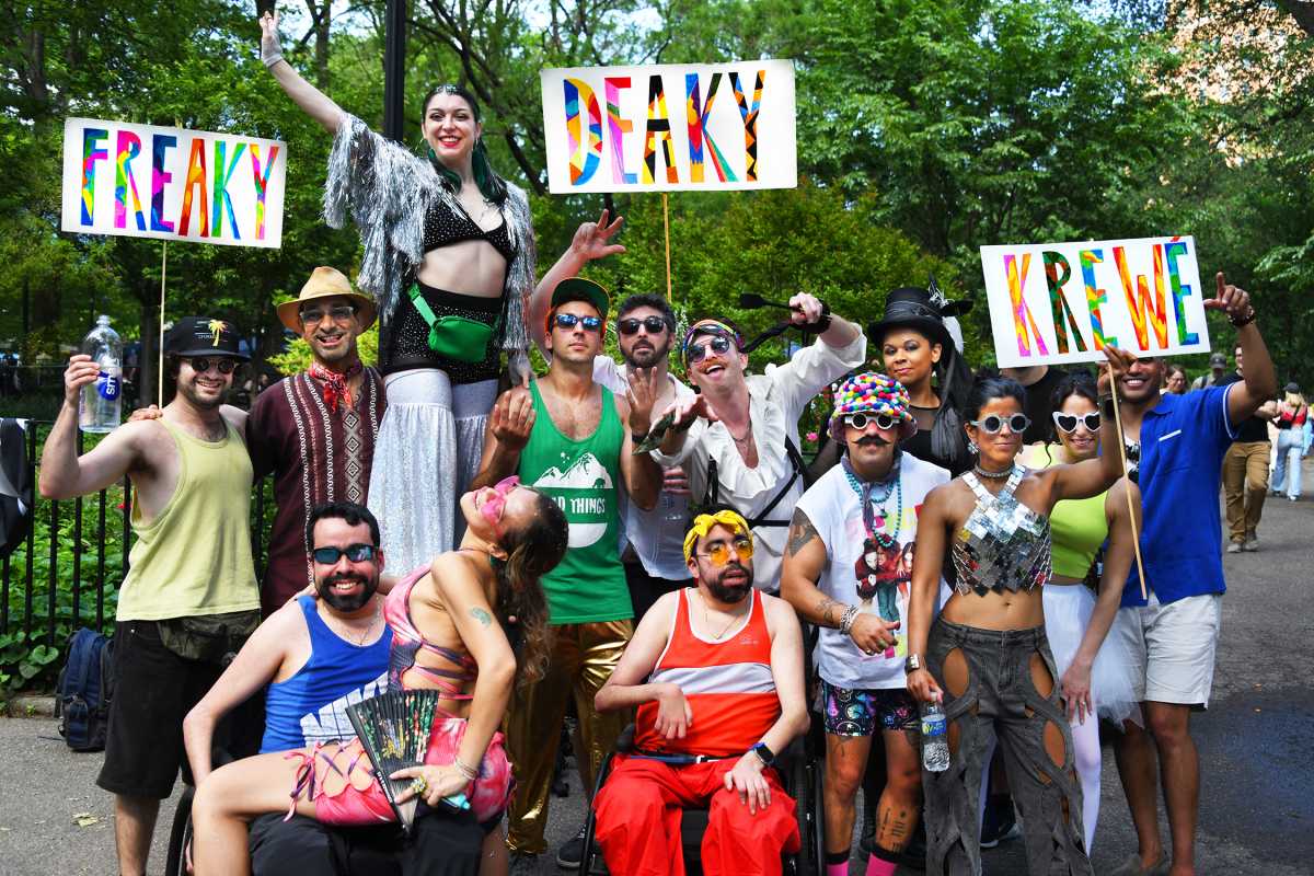 People holding signs at Dance Parade and Dance Fest in East Village
