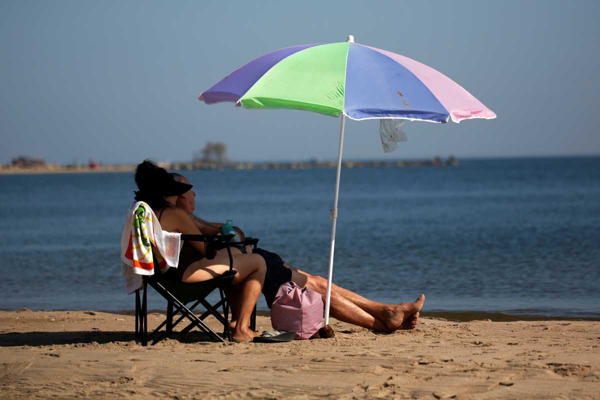 People basking in the sun in Orchard Beach in the Bronx. 