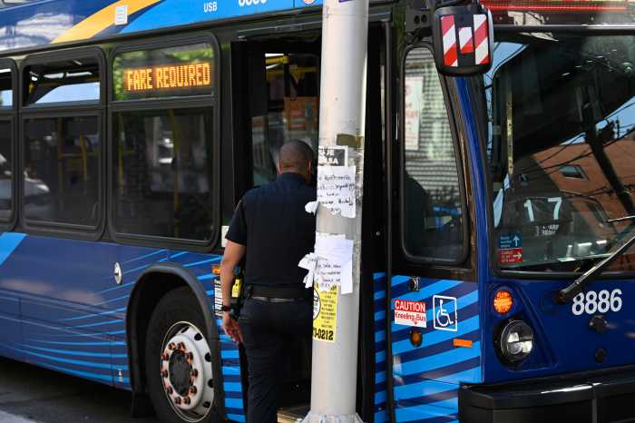 police officer standing next to a bus in Brooklyn