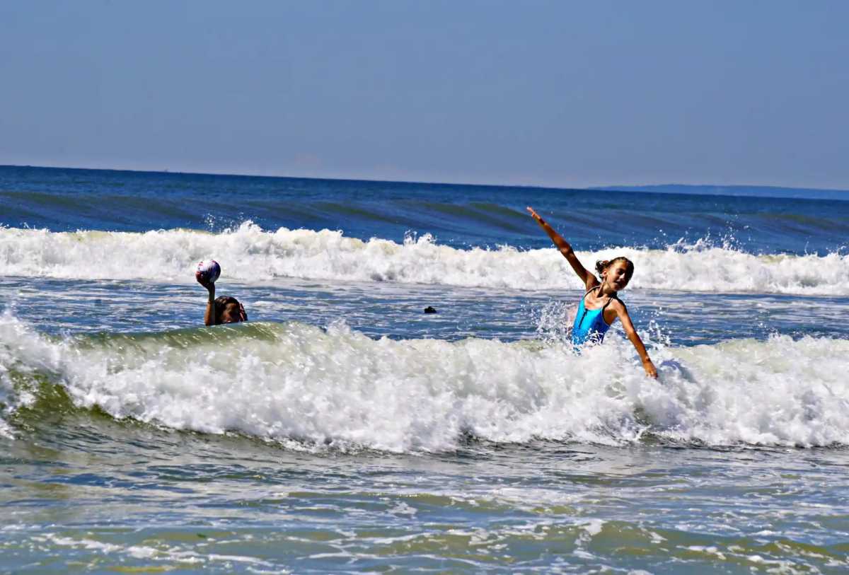 Kids swimming off Rockaway Beach