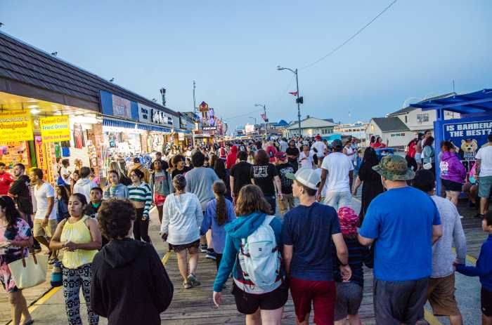 tourists walking on boardwalk in Wildwood on Jersey Shore during summer