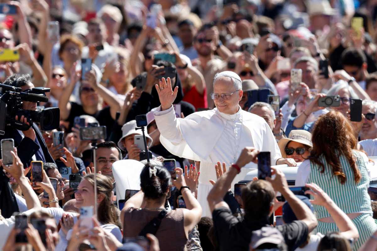 Pope Leo XIV waving to crowd of people in Rome