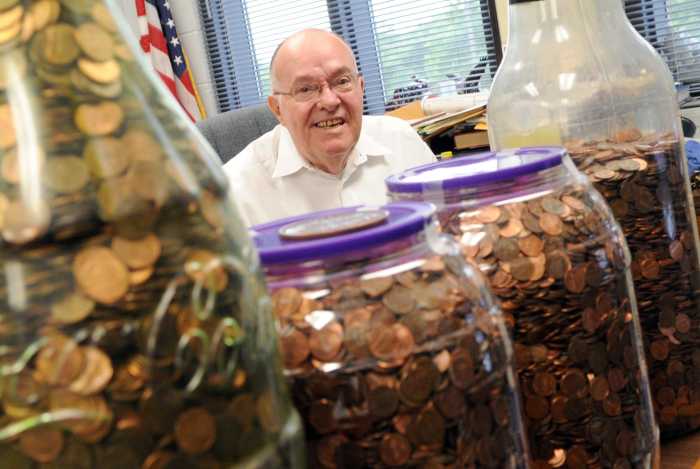 Richard Bean, superintendent of the Richard L. Bean Juvenile Detention Center, poses with pennies he has collected for the Pennies for Undies program at his office Friday, July 17, 2011. Bean has collected 52,000 so far and hopes to reach 100,000 pennies t