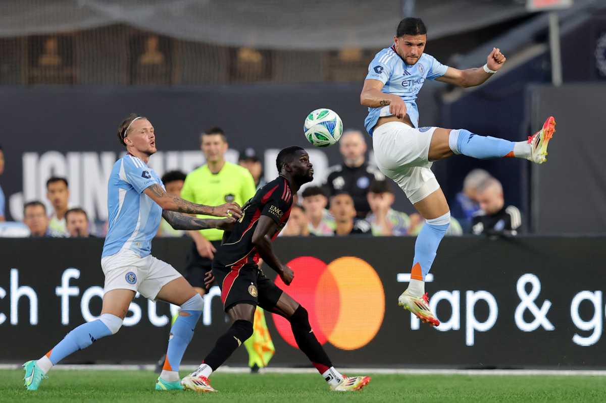 Jun 12, 2025; New York, New York, USA; New York City FC midfielder Justin Haak (80) plays the ball past Atlanta United forward Jamal Thiare (14) and New York City defender Birk Risa (5) during the first half at Yankee Stadium. Mandatory Credit: Brad Penner-Imagn Images