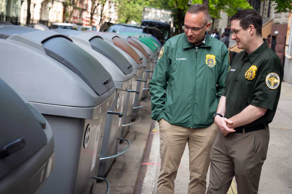 West Harlem hits 100% trash containerization as New York ramps up battle against rats 2 Sanitation workers in West Harlem look at trash containers during containerization