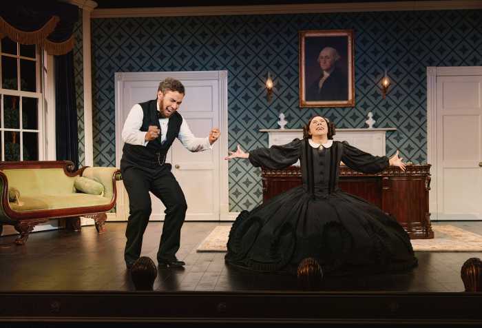 man dressed like abraham lincoln with actor dressed in 1850s dress arms outstretched
