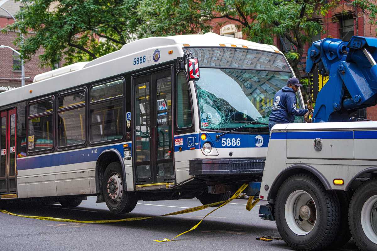 an MTA bus gets towed away after a fatal crash