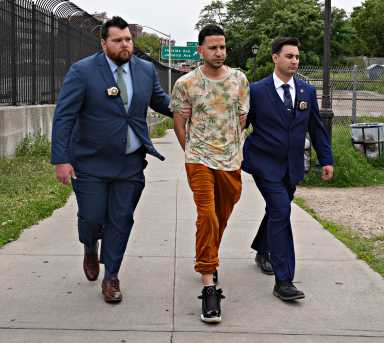 Suspect in pepper spray attack on mom and baby in Queens subway station arrested and escorted. by cops