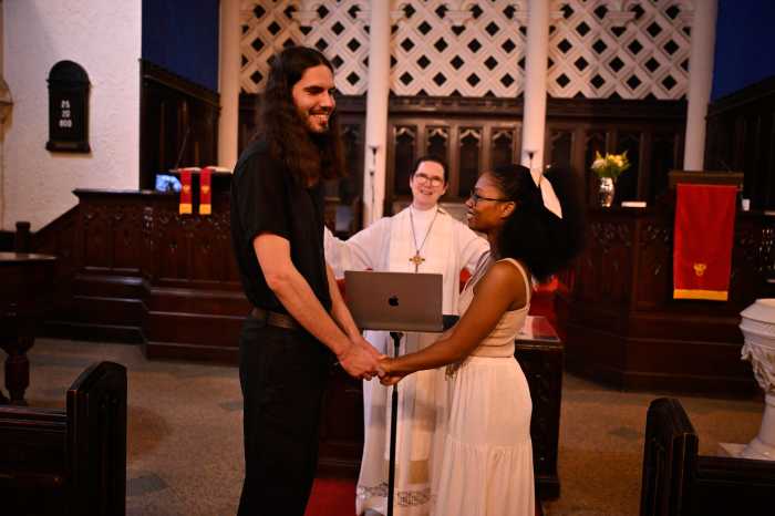 Maksim Reviaka, (left) stands next to his wife Akeelah while taking vows during their marriage cereomy at Second Presbyterian Church on Sunday, June 22. Reviaka is set to face a deportation hearing on July 1.