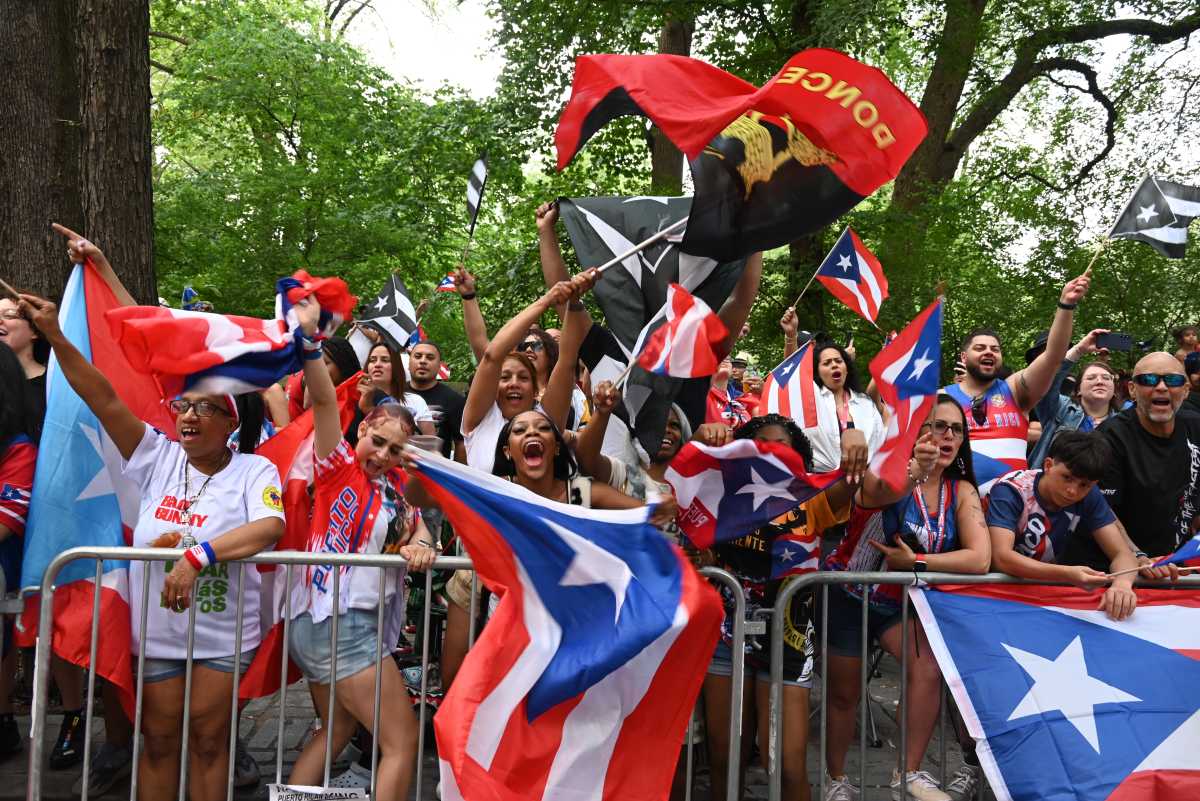 Bongo drum beats and the celebratory blare of trumpets reverberated throughout the cluster of storefronts and office buildings during Sunday's National Puerto Rican Day Parade in Midtown. 