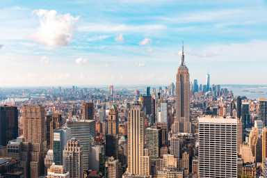 Iconic buildings overlooking bustling new york city with impressive architecture and vibrant energy in warm sunlight