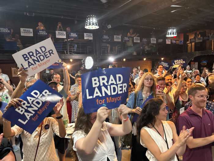 NYC Mayor's Race: Third-place Lander concedes but celebrates Mamdani's apparent win, Cuomo's apparent loss 2 crowd of people holding signs at Lander headquarters