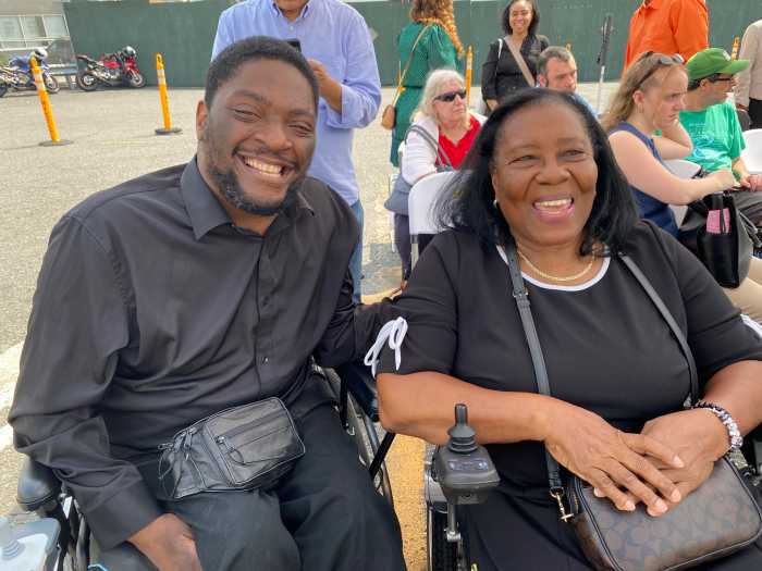 two people smiling and dressed in black