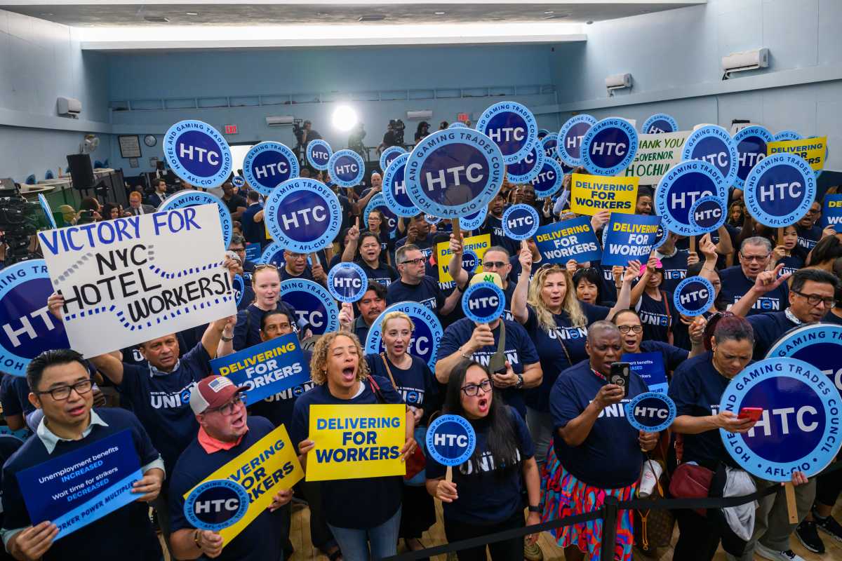 New York State increases unemployment benefits by more than $300 per week, pays off federal unemployment trust loan 2 People holding blue and yellow signs celebrating increase in unemployment benefits