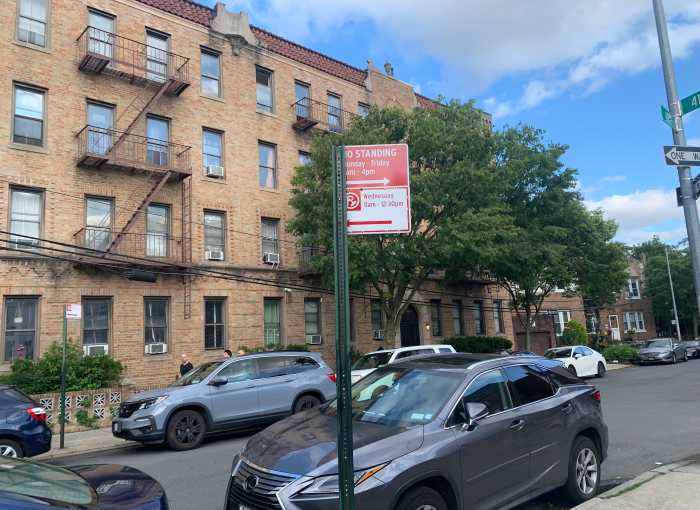a street sign showing street-cleaning rules in nyc