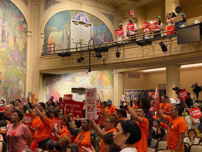 People wearing bright shirts protesting rent hike