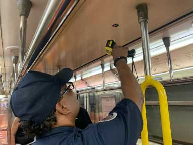man taking the temperature on a rail car of one of many MTA subways