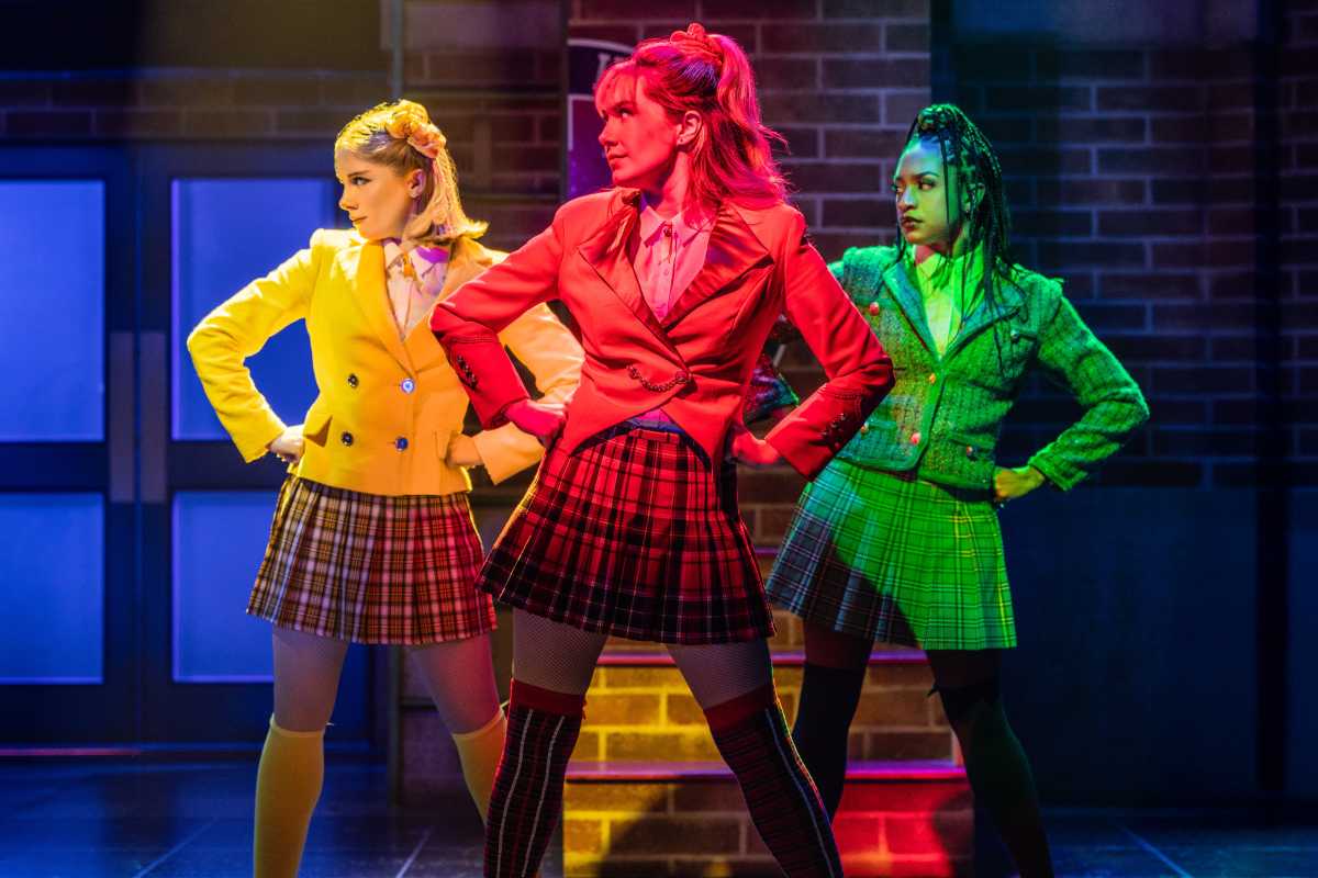 Review | Slushies, scrunchies and serial killers: ‘Heathers’ returns with a vengeance 2 three women set in yellow, red and green broadway lighting