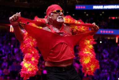 man in red shirt, boa and sunglasses Hulk Hogan tears off shirt