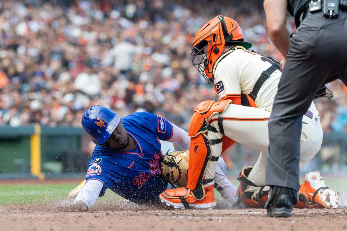 Jul 20, 2025; New York City, New York, USA; New York Mets right fielder Juan Soto (22) scores before being tagged by Cincinnati Reds catcher Tyler Stephenson (37) during the eighth inning on a fielder choice hit by catcher Luis Torrens (not pictured) at Citi Field.