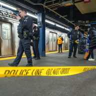 Lower Manhattan subway stabbing: Suspect attacked on train after argument, cops say 5 nypd officers in blue on subway platform with yellow crime scene tape stretched