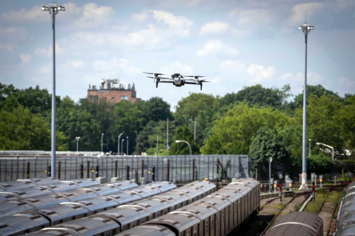 A police drone over subway cars on tracks in effort to stop subway surfing
