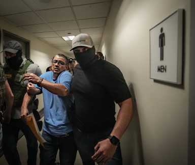 Masked guards for ICE escort immigrant