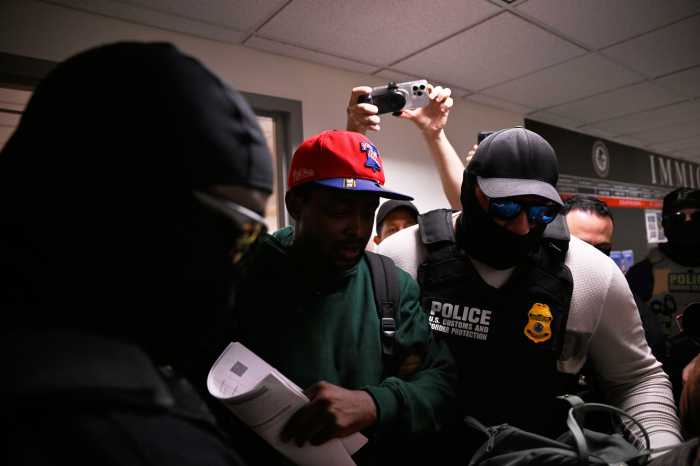 An immigrant is detained by ICE agents moments after exiting a mandatory hearing inside Manhattan’s 26 Federal Plaza.