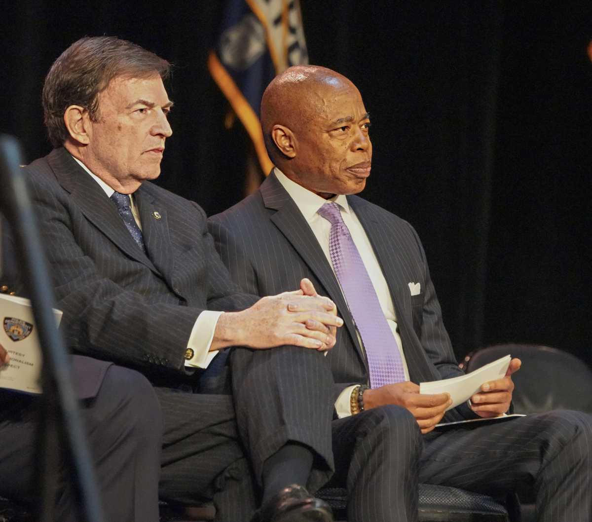 two men sitting and looking intently at something