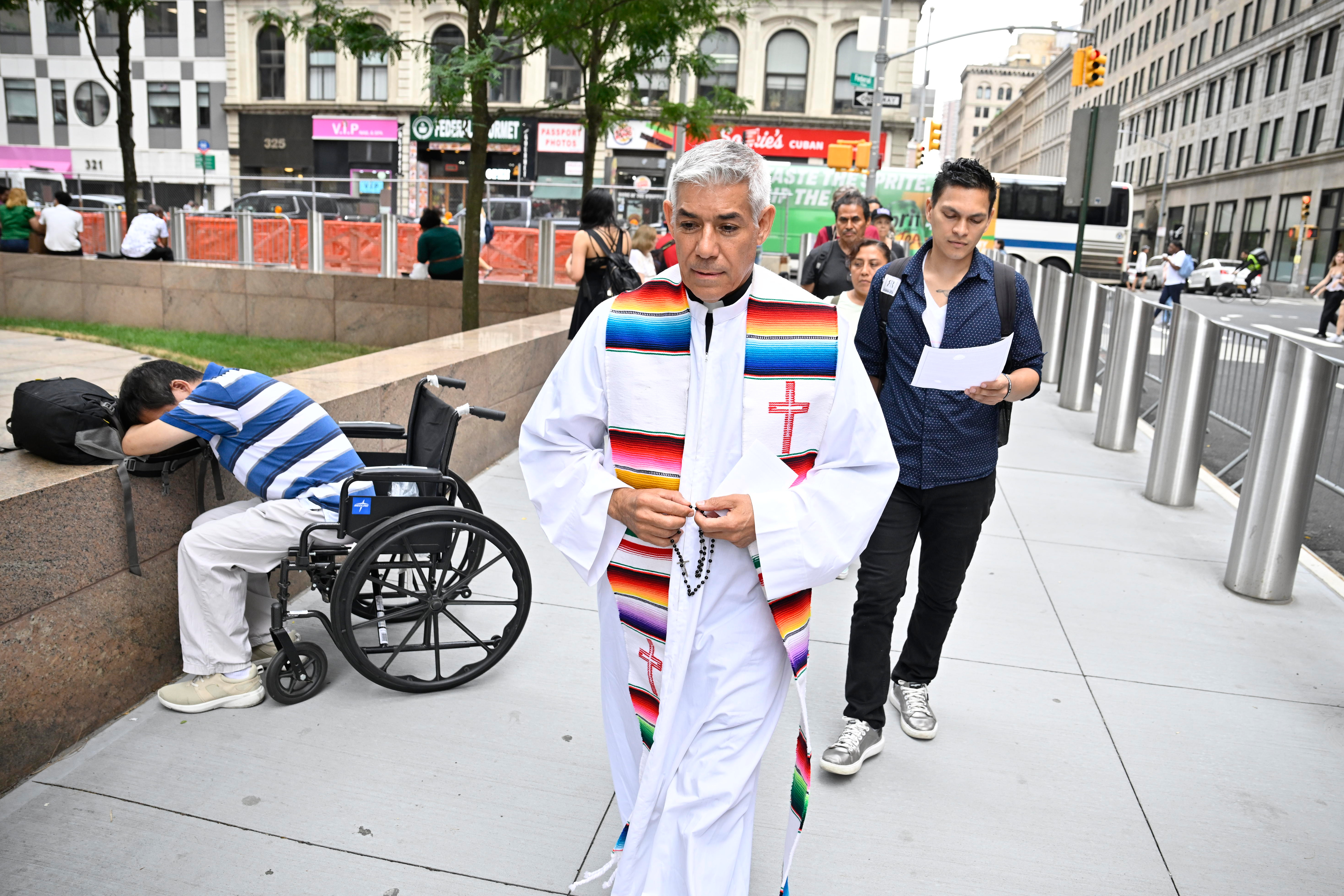 The Jericho walk, led by Pastor Fabian Arias, passes Federal Plaza on July 10.