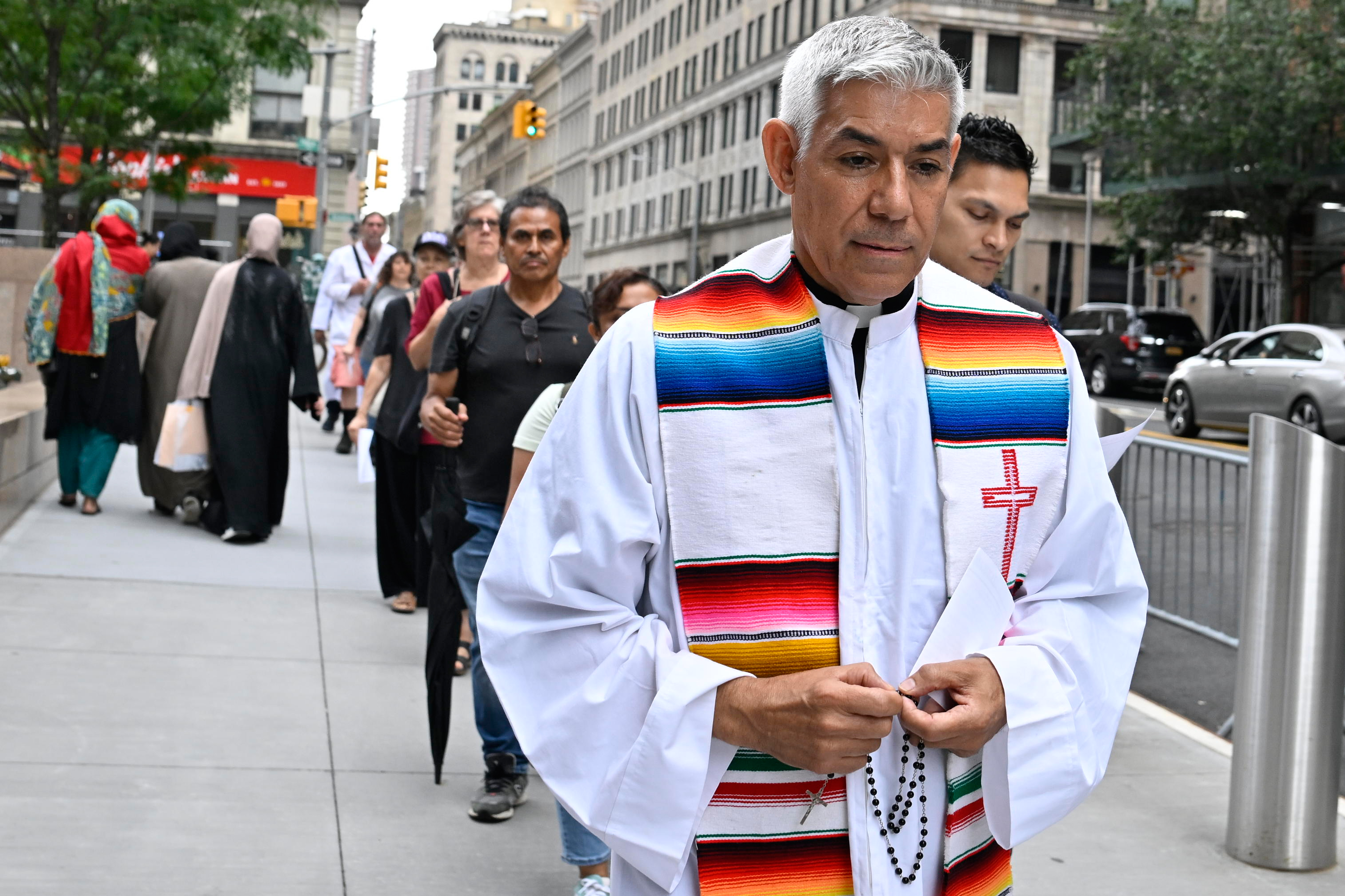The Jericho walk, led by Pastor Fabian Arias, passes Federal Plaza on July 10.