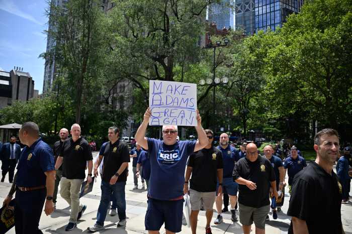 NYC Mayor's Race | Law enforcement unions back Eric Adams for re-election, unfazed by corruption allegations 3 Union members and supporters arrive at City Hall, with one supporter holding a “Make Adams Great Again” sign