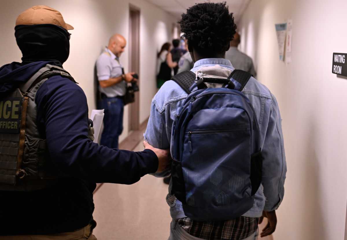 A ICE Agent detains a man following a hearing at 26 Federal Plaza on the 14th floor on July 24.