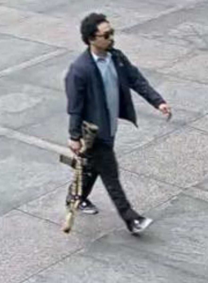 man with assault rifle walking before mass shooting