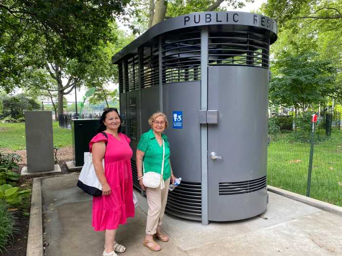 two women standing in front of park toilet in New YOrk