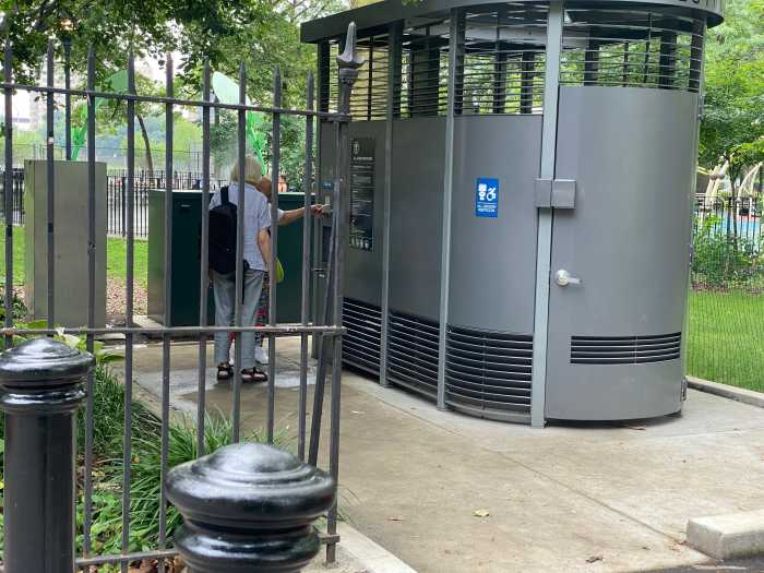 Maria, known as Greeny, shows off the new $1 million Portland Loo to fellow East Harlem resident Antje at Thomas Jefferson Park on Wednesday,