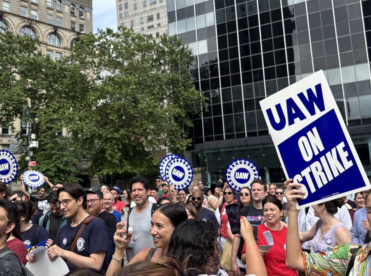 Group of people holding banners reading on strike
