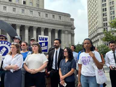 Zohran Mamdani stands with a group at a union rally.