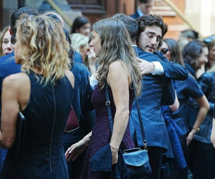 Mourners console one another outside Central Synagogue after the funeral for Julia Hyman on Wednesday, July 30. The 26-year-old real estate associate was remembered for her warmth, loyalty, and love of life.