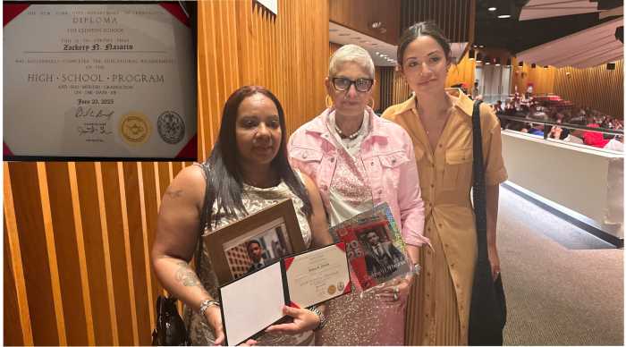 Norma Nazario accepts a posthumous high school diploma on behalf of her late son, Zackery, during a graduation ceremony at The Clinton School. She is pictured with Ida Cesarano of The Clinton School, and New York City Councilwoman Carlina Rivera. 