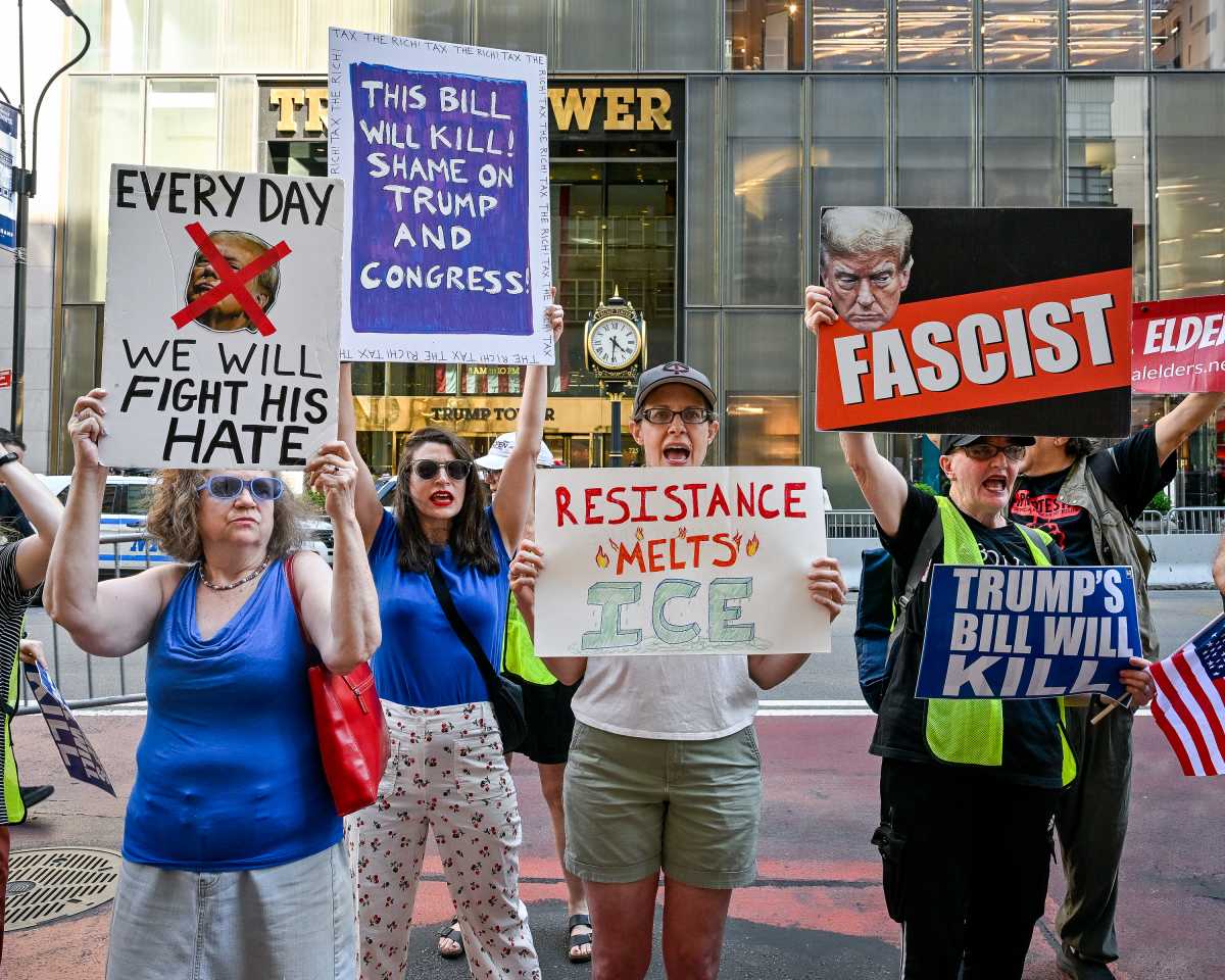 July 4 protesters in Midtown sound the alarm against Trump's 'Big Beautiful Bill,' now the law of the land 2 People holding signs reading Fascist and condemning Trump for policies