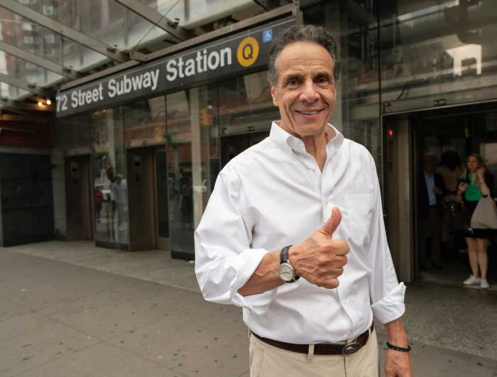 man wearing shirt holding thumbs up near subway station in campaign