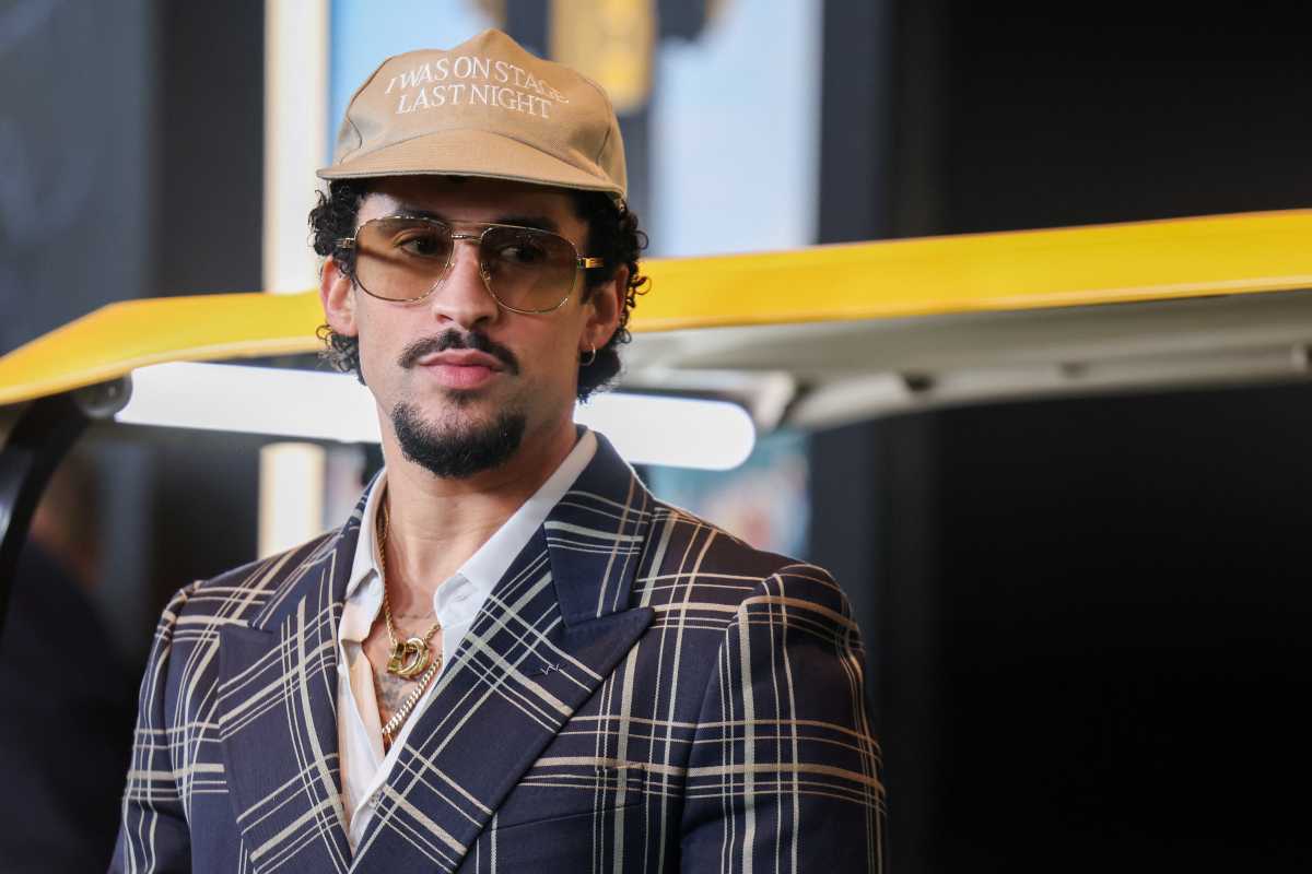 Bad Bunny brings buzz to Bronx bakery with summer anthem 2 Bad Bunny on red carpet wearing tan hat and checkered blazer