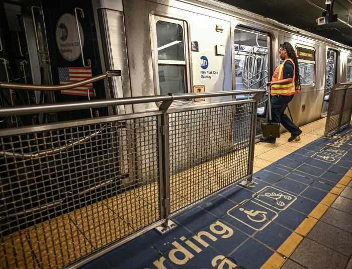 a woman wearing a brightly colored vest enters a train