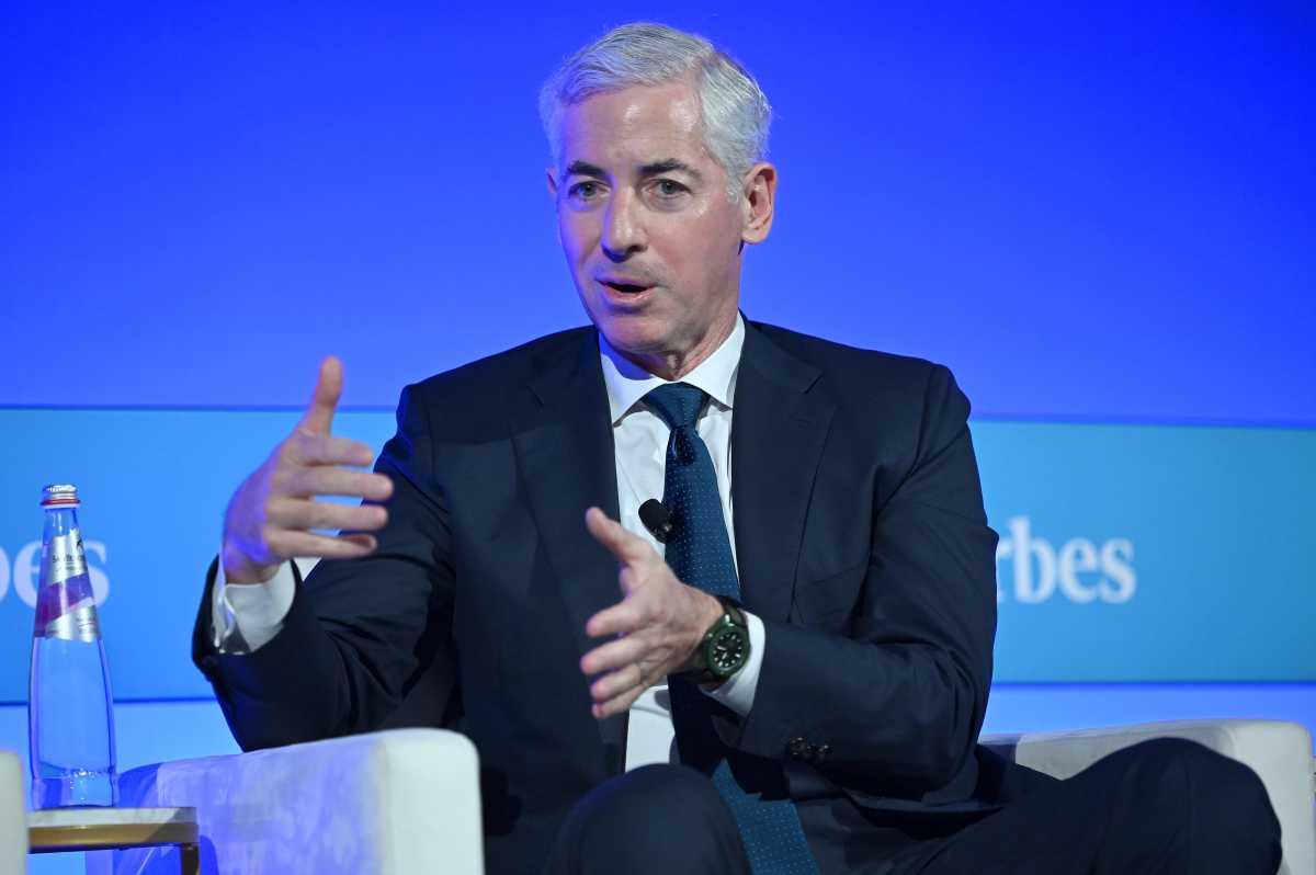 man in blue suit speaking with his hands