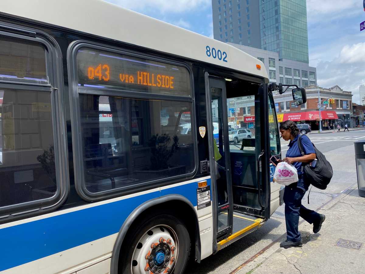 person getting on a NYC bus during the day