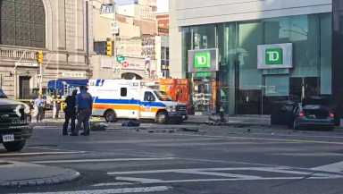 police officers and ambulance at scene of hit-and-run crash in Chinatown with debris on ground