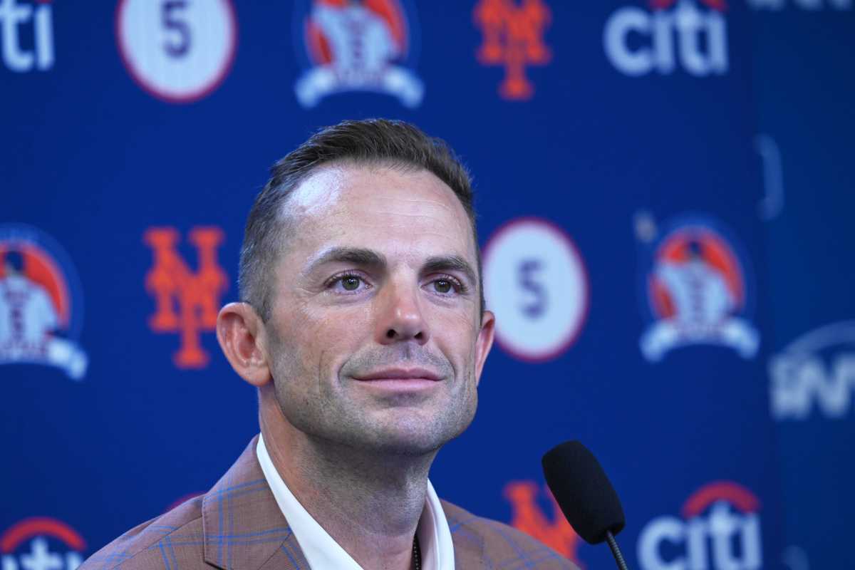 David Wright: Man in suit smiles in front of blue and orange backdrop